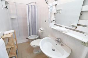 a white bathroom with a sink and a toilet at Casa Vacanza Primitivo di Manduria in Otranto +34 photos