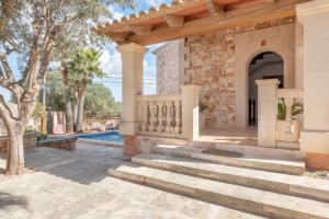 an estate with a swimming pool and a stone house at Es Cantó in Cala Llombards