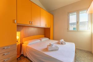 a bedroom with a bed with two towels on it at Vista Mare in Santa Croce Camerina