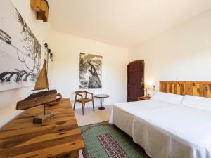 a bedroom with a bed and a table and a chair at Can Picca in Illes Balears +37 photos