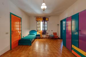 a living room with a couch and colorful doors at Sprocketlandia in Frigole