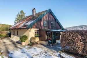 a small house with snow on the ground at Uriges Landhäuschen in Siegsdorf