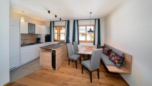 a kitchen and dining room with a table and chairs at Himml Schlosshof in Völs am Schlern