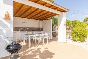 a kitchen with a table and chairs on a patio at Villa Andes in Benissa