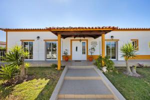 a house with a pathway leading to the front door at Villa Oliveira in Aljezur