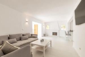 a white living room with a couch and a table at Villa Andes in Benissa