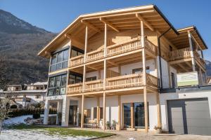 a large house with a mountain in the background at Apt Eiche - Nockerhof in Andrian