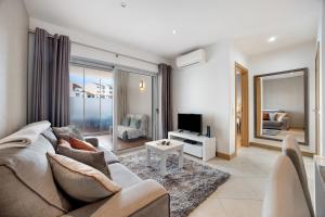 a living room with a couch and a tv at Tourismer C in Lagos