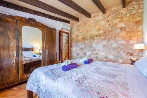 a bedroom with a bed with a teddy bear on it at Ses Oliveres in Campos +19 photos