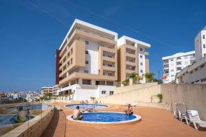 a group of people in a swimming pool in front of a building at Tourismer C in Lagos