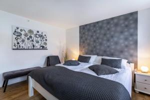 a bedroom with a large bed with a gray headboard at Ferienwohnung Butjes in Sollwitt