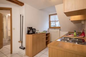 a kitchen with a sink and a stove in it at Ferienwohnung Nr 2 in Deggenhausertal +17 photos