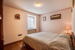 a bedroom with a bed and a window at Appartamento Le Coccinelle in Varena
