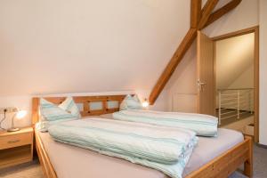 two twin beds in a room with a mirror at Ferienwohnung Nr 2 in Deggenhausertal
