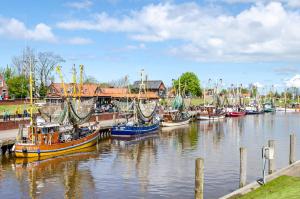 a bunch of boats are docked in a harbor at Ferienhaus Grietjes Huus in Krummhörn