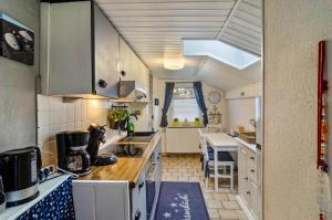 a kitchen with a sink and a counter top at Ferienhaus Grietjes Huus in Krummhörn