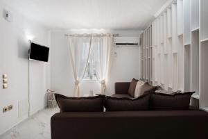 a living room with a couch and a window at Villa Drosia in Volímai