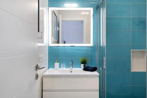 a bathroom with a white sink and a mirror at Brisa 3 in La Santa +15 photos