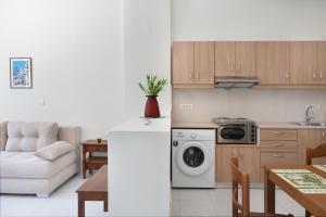 a kitchen and a living room with a dishwasher at Port House in Kos +15 photos