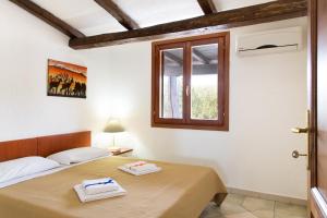 a bedroom with two beds and a window at Belvedere in San Teodoro