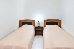 two beds sitting next to each other in a room at Port House in Kos