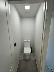 a small bathroom with a toilet in a room at kambariu nuoma in Dovilai +3 photos