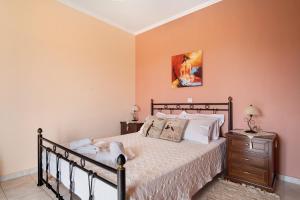 a bedroom with a bed and a nightstand with a bed sidx sidx sidx sidx at Lakis Apartment in Meganisi