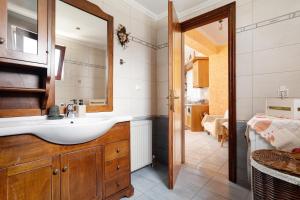 a bathroom with a sink and a mirror at Lakis Apartment in Meganisi +15 photos
