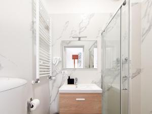 a white bathroom with a sink and a shower at Casa Bella Venezia 2 in Mestre