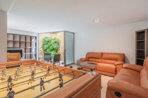 a living room with a table and a large chess board at Villa Agusmar in Llucmajor