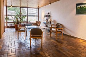 a waiting room with tables and chairs and windows at Ferienwohnung Fetscher 2 in Reichenau