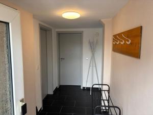 a hallway with a staircase with two chairs and a door at Ferienapartment Dörfles-Esbach in Dörfles +2 photos