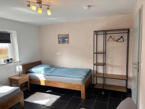 a bedroom with a bed and a book shelf at Ferienapartment Dörfles-Esbach in Dörfles