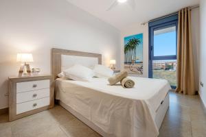 a bedroom with a large white bed with a window at Cambrils Platja in Cambrils +23 photos