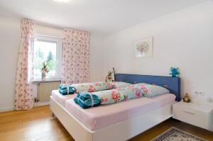 a bedroom with a bed with a blue headboard at Aida in Überlingen