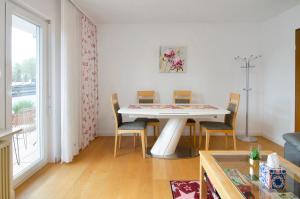 a dining room with a white table and chairs at Aida in Überlingen