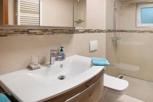 a bathroom with a white sink and a shower at Aida in Überlingen +26 photos