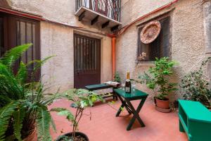 a patio with a table and some plants and a building at Il Baglio Antico in Prizzi