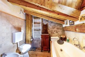 a bathroom with a toilet and a bath tub at Arpy an in Morgex +20 photos