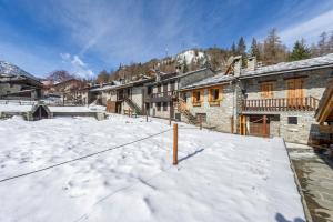 a snow covered yard with buildings in the background at Arpy an in Morgex