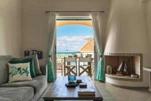 a living room with a couch and a fireplace at Villa Millianna Exclusive Apartment in Kefallonia