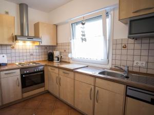 a kitchen with a sink and a window at Haus Wanderglück in Schmallenberg