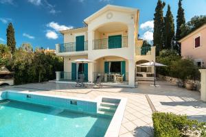 a villa with a swimming pool and a house at Villa Millianna Exclusive Apartment in Kefallonia