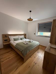 a bedroom with a bed and a window at Apartment Moné - Kope in Slovenj Gradec