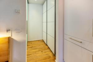 a hallway with a glass door and a wooden floor at Ferienwohnung Sonnenhalde in Moos