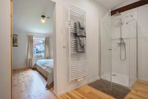 a white bathroom with a shower and a bed at Taubenkobel in Groß Wokern +34 photos