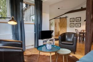 a living room with a couch and a table at Taubenkobel in Groß Wokern