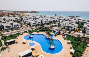 an aerial view of a resort with a swimming pool at Nothern Cyprus Four Seasons Life Collection Apartments & Lofts Seafront in Ayios Dhometios