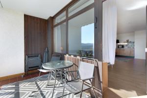 a dining room with a glass table and chairs at Fewo S22 in Regen