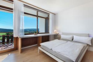 a bedroom with a bed and a large window at Fewo S22 in Regen